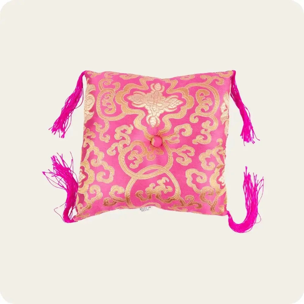 Pink and gold Tibetan singing bowl cushion, designed for spiritual practice and decoration.